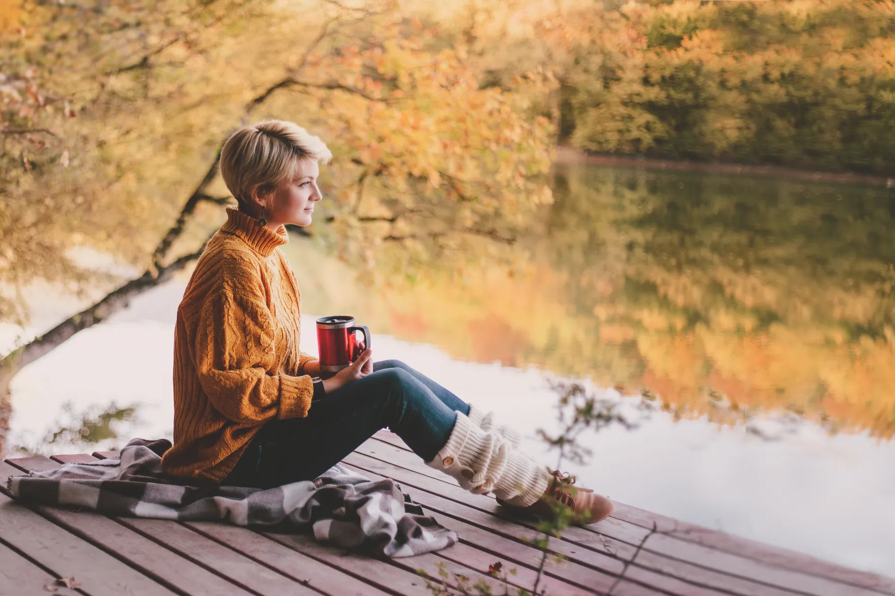 A person pausing to take a slow, steadying breath in a quiet, calm space.
